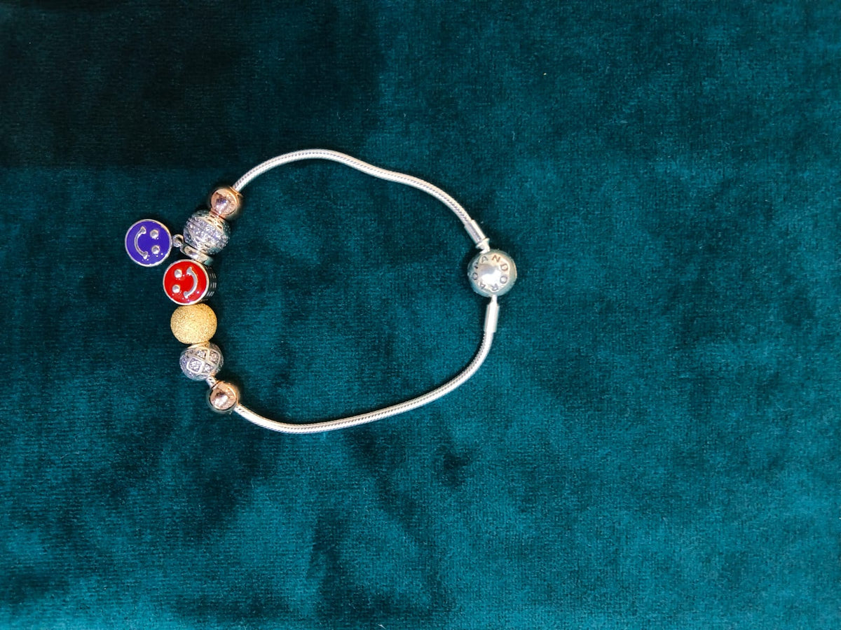 925 silver smiley face charm bracelet on teal velvet