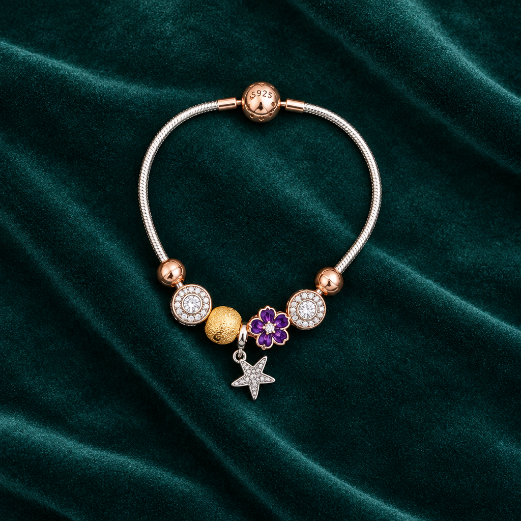 925 silver rose gold charm bracelet flat lay on teal velvet