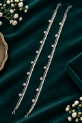 925 silver daisy anklet flat lay on teal velvet