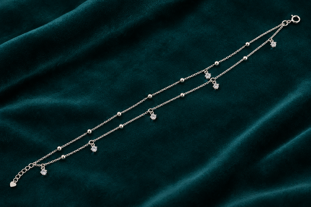 925 silver crystal stone charm anklet flat lay on teal velvet